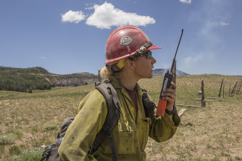 Photo of firefighter talking into handheld radio at Brianhead Fire in Utah